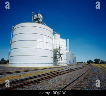 Grain Silos beside Railway Line Stock Photo