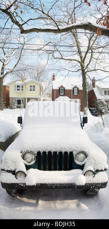 Snow Covered Jeep in Driveway Stock Photo