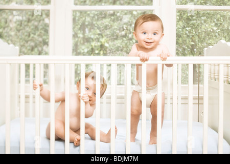 Twin Boys in Crib Stock Photo