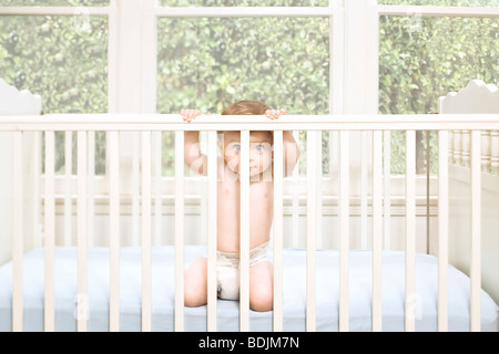 Baby Boy in Crib Stock Photo