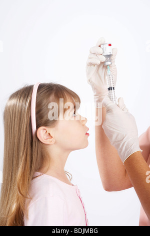 Little Girl Watching Nurse Prepare a Needle Stock Photo