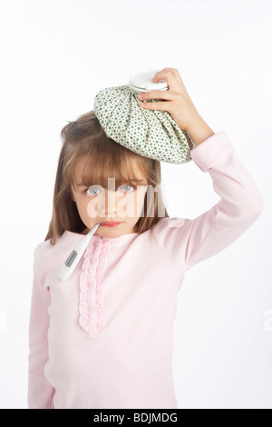 Girl With a Thermometer in Her Mouth and an Ice Pack on Her Head Stock Photo