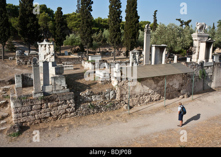 A man admires the sculpted grave stelae of the Kerameikos (ancient cemetery) of Athens, Greece. Stock Photo