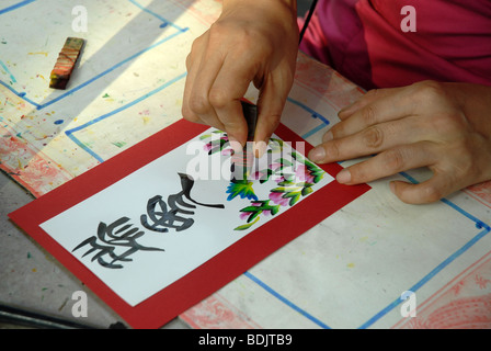 Chinese calligraphy artist at work, Chinatown, Singapore Stock Photo