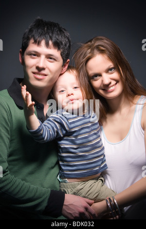 Happy family. On dark background. Stock Photo