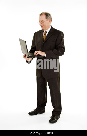 A caucasian businessman with a receding hairline wearing a black business suit and white shirt. Stock Photo