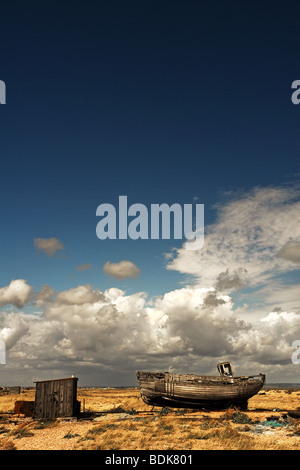 Abandoned fishing boat and hut on the shingle at Dungeness in Kent ...