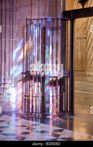 Spain , City of Valencia , Gothic La Lonja begun 1483 , interior internal iron gate or door illuminated by stained glass window Stock Photo