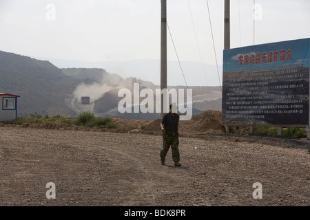 AN TAI BAO MINE, SHANXI PROVINCE, CHINA - AUGUST 2007: trucks throw up  dust as they collect coal from this vast open cast mine Stock Photo