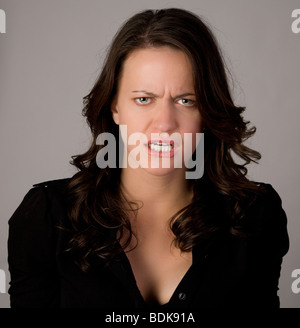 woman with angry expression grinding teeth Stock Photo - Alamy