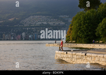 Bike riding on the coastal trail in Stanley Park, Vancouver, British Columbia, Canada. (model released) Stock Photo
