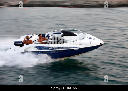 A motor boat in front of Dubai Marina, a district in the south of Dubai, Dubai, United Arab Emirates