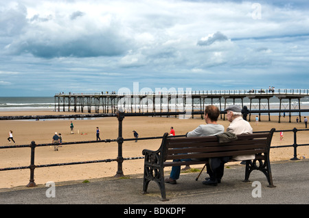 Father and Son Sat On Bench At The Seaside Stock Photo
