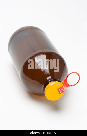 Bottle of fruit juice with yellow metal cap on white background Stock Photo