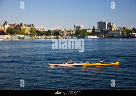 Kayakers pass Songhees Viewpoint in the Inner Harbour, Victoria, Vancouver Island, British Columbia, Canada. Stock Photo