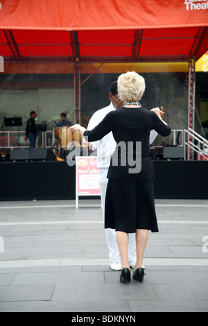 Glamorous mixed race elderly couple dancing in the foyer at The Royal Festival hall South Bank London Stock Photo