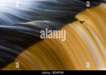 Close up detail of water flowing over the edge of Stainforth Force Waterfall near Settle, Yorkshire Dales Stock Photo