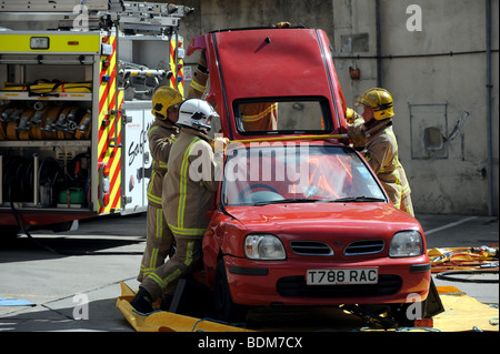 Firefighters demonstrate how to cut free a driver from a crashed car at the Preston Circus Fire Station Open Day in Brighton Stock Photo