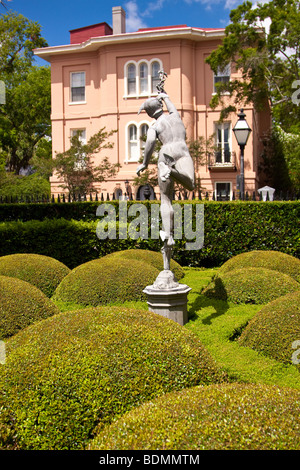 A statue of Mercury graces the formal gardens of the Calhoun Mansion built in 1876 at 16 Meeting Street in Charleston, SC Stock Photo