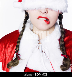young funny and expressive woman dressed as santa claus is doing her shopping Stock Photo