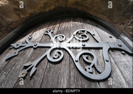 Large ornate door hinge on a church door Stock Photo