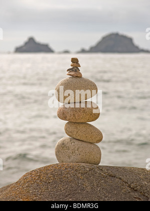 Two small rocks balanced on a large rock on the beach at Gairloch ...