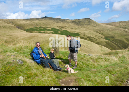 Walkers resting as they climb Jacob's Ladder up to Kinder Scout, near Edale, Peak National Park, Derbyshire, England UK Stock Photo