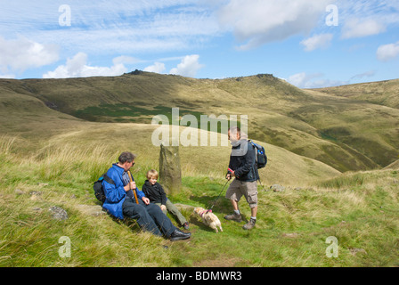 Walkers resting as they climb Jacob's Ladder up to Kinder Scout, near Edale, Peak National Park, Derbyshire, England UK Stock Photo
