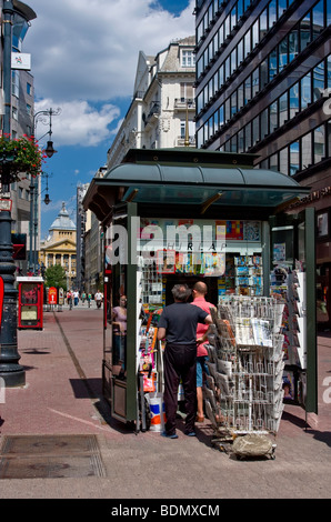 People buying newspapers at a kiosk in  Budapest street Stock Photo