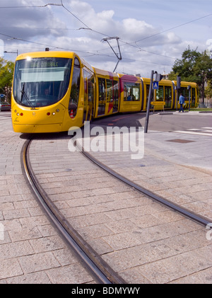 Yellow Orange City Tram taking a curve, Mulhouse France Stock Photo