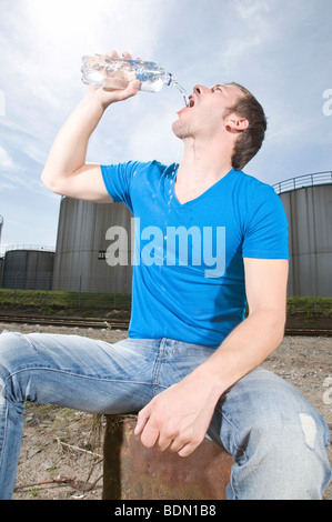 Young man drinking Stock Photo