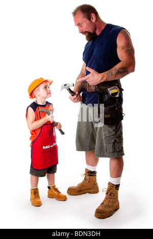 A big guy father with his son, carpenters, holding hammers while dad is explaining by pointing at his tool, isolated. Stock Photo