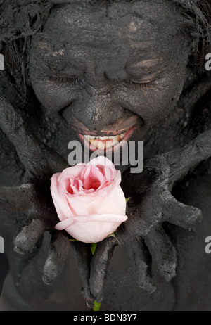 portrit of crying dirty girl holding pink rose Stock Photo