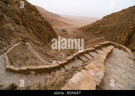 Thousands of stairs climb the desert mountains to reach the Mar Musa (Saint Moses), monastery in Syria. Stock Photo