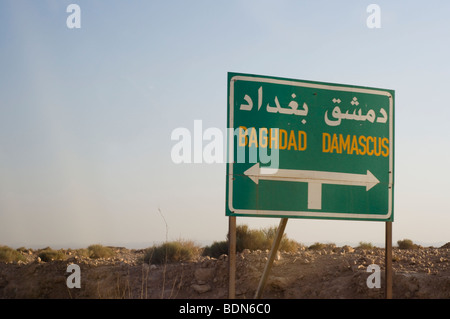 Road signs along a Syrian highway point the way to Baghdad, Iraq and the Syrian capital of Damascus. Stock Photo