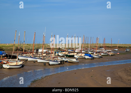 Many yachts moored on a creek bank at low tide in Morston, North Norfolk, England Stock Photo