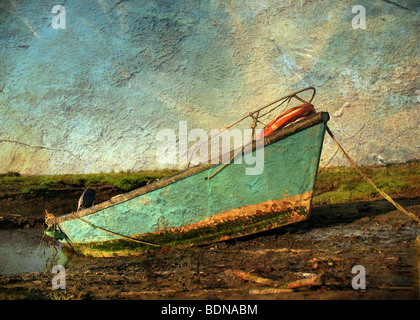 A small boat on mud flats with texture Stock Photo
