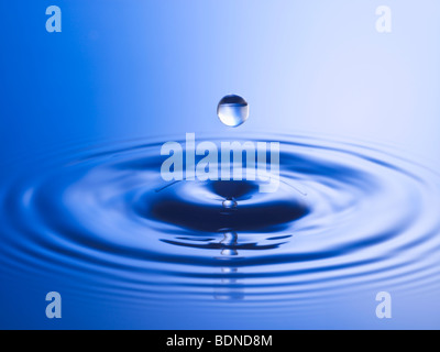 Drop hitting surface of water, close-up Stock Photo