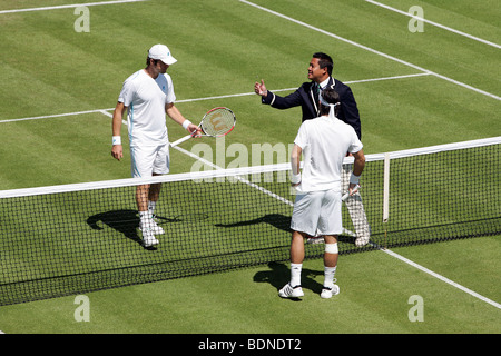 The umpire tosses the coin before the start of the game on court 18 during the 2009 Wimbledon Tennis Championships Stock Photo