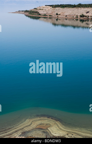 Mineral deposits ring the eastern shore of the Dead Sea in Jordan. Stock Photo