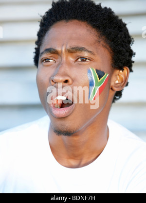 Sports fan with South African flag painted on his cheek. Cape Town, Western Cape Province, South Africa Stock Photo