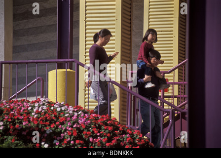 Young father carries daughter on shoulders while shopping Stock Photo