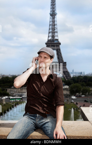 Young man in front of the Eiffel Tower, Paris, France, Europe Stock Photo