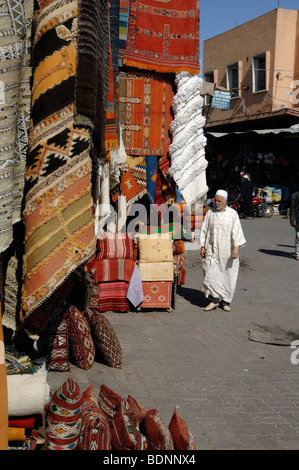 Moroccan Muslim Arab Man Wearing a Jellaba in the Carpet Bazaar, Market or Souk, Marrakesh, Morocco Stock Photo