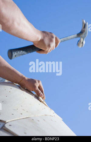 Carpenter working on the turret of a house Stock Photo
