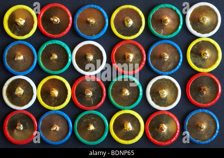 Drawing pins pattern, rows of colourful drawing pins in a square close up - looking down on from above Stock Photo