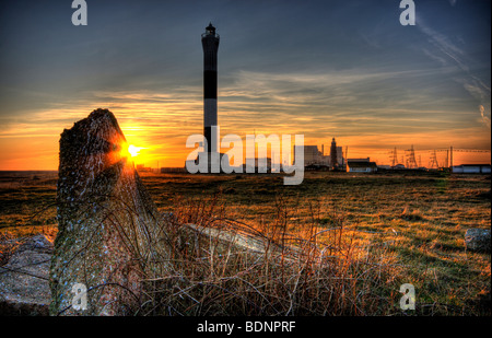 Sunset at Dungeness with both the old and new lighthouses and the nuclear power station Stock Photo