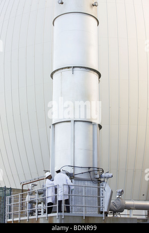 Two scientists examining an exhaust stack Stock Photo