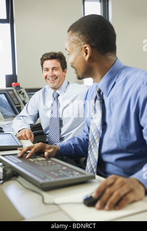 Two operating engineers working in a control room Stock Photo