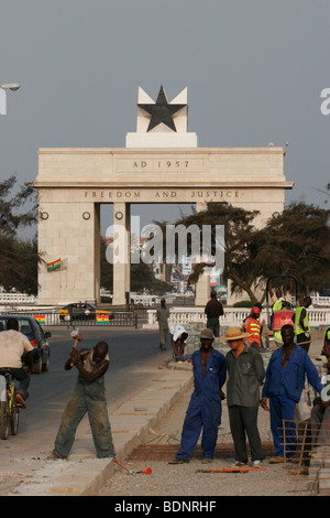 Road workers led by Chinese foreman repair the pavement near Independence Square and the Black Star monument. Accra. Ghana. Stock Photo
